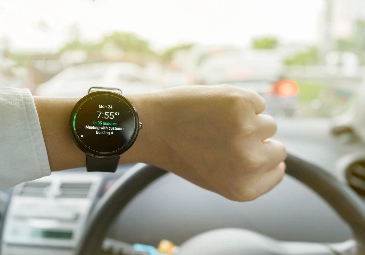 A person wearing a watch while driving